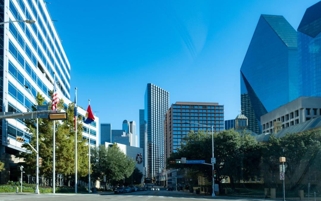 a city street with tall buildings in the background