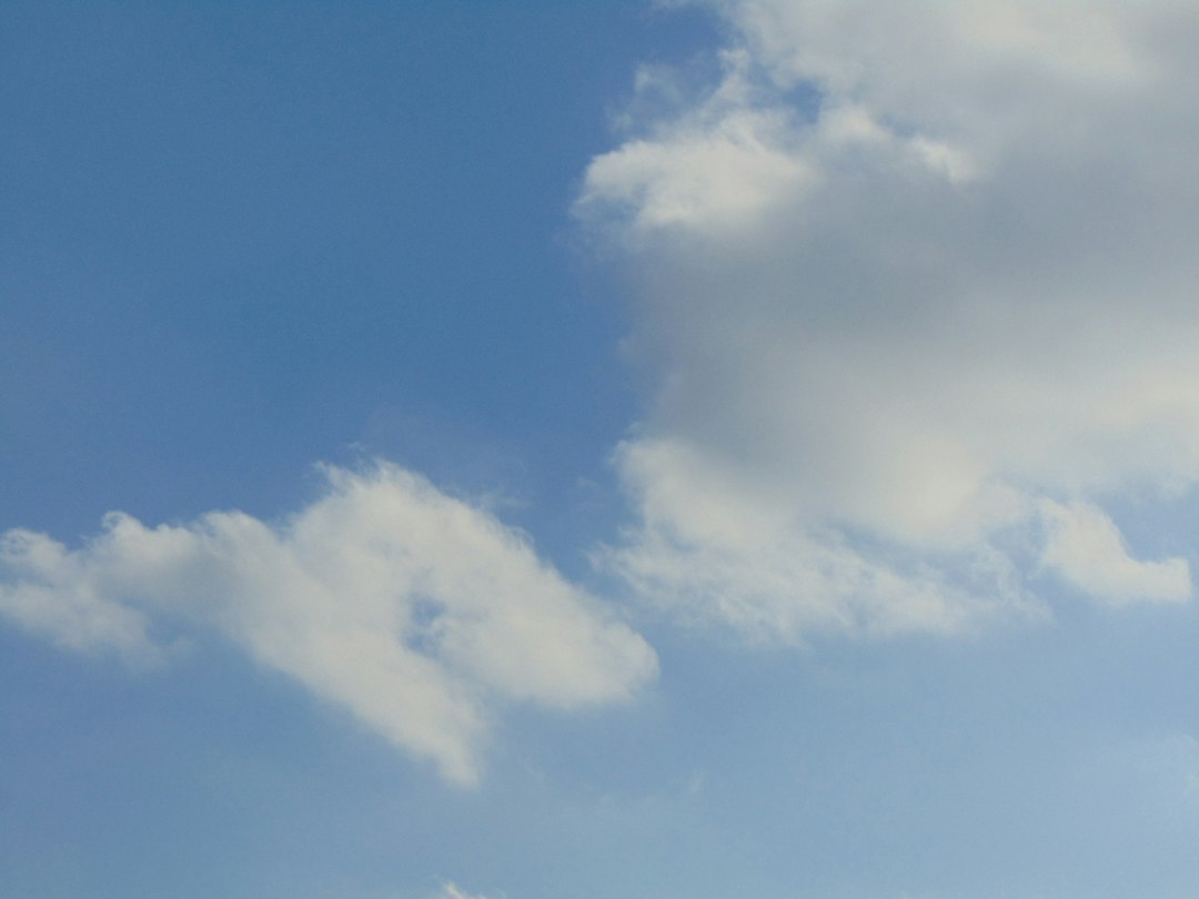 a group of people flying a kite in the sky 1