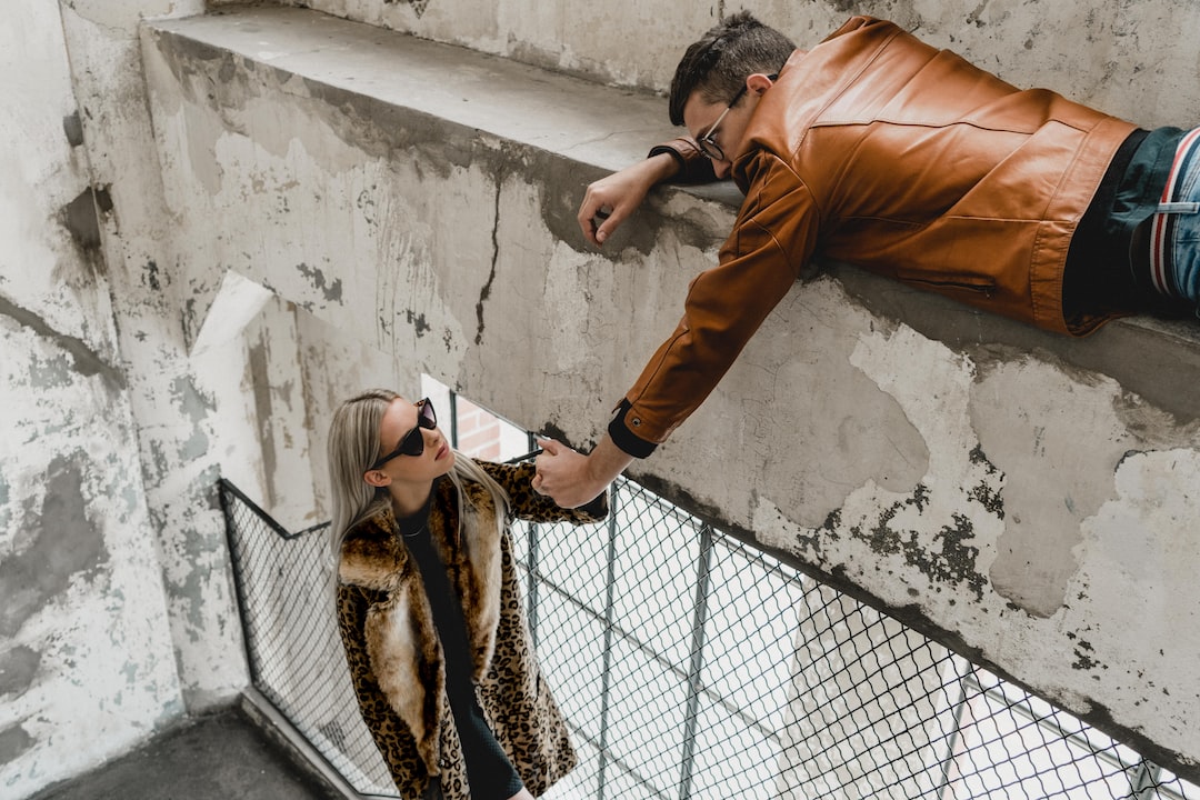 man holding hand to woman