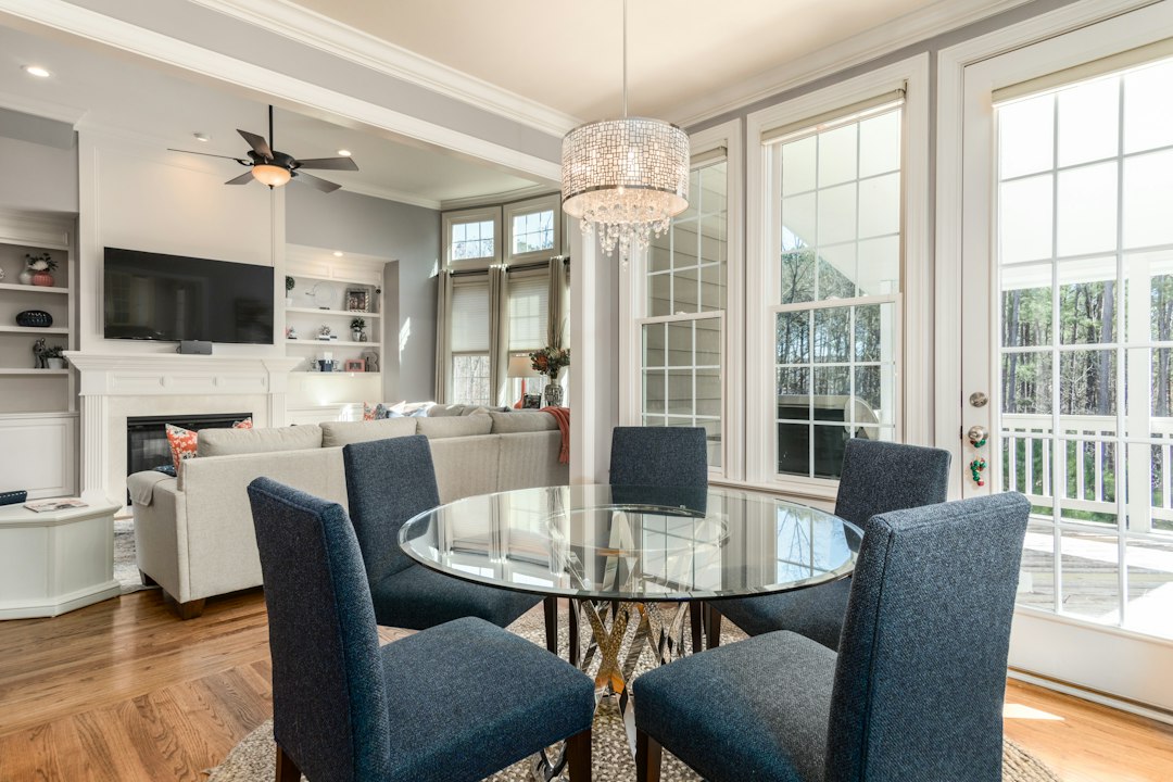 round clear glass top table and five gray chairs dining se