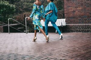 two women in teal romper pants