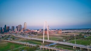 an aerial view of a city with a bridge in the foreground
